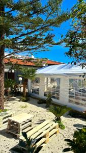 a white house with a picnic table in front of it at La dimora dei Turchì in Otranto +15 photos
