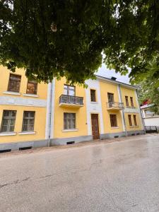 a yellow building on the side of a street at Ljubez Apartment in Jajce