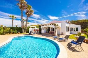 a villa with a swimming pool and a house at Villa Miguel Dos in Cala en Bosc