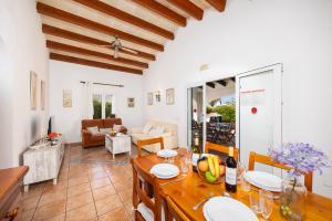 a kitchen and living room with a table and chairs at Villa Miguel Dos in Cala en Bosc