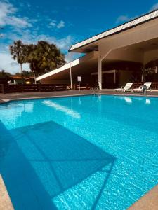 a large swimming pool with blue water in front of a building at Ceta Ecotel in Macapá