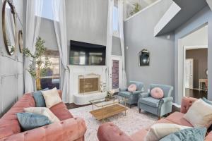 a living room with two couches and a fireplace at French-Style 5-BD w/ Pool, Playground, Cinema in Lewisville