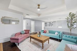 a living room with two couches and a table at French-Style 5-BD w/ Pool, Playground, Cinema in Lewisville