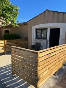 a wooden fence in front of a house at Les Cigales in La Crau