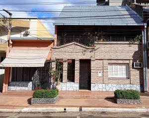 a brick house with an awning on a street at La Casa de Sol in Posadas