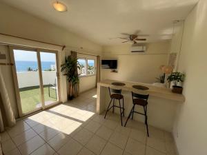 a kitchen with a table and two stools in a room at Estudio con vista al mar #5 in San José del Cabo