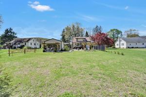 a large yard with houses in the background at Cozy Home Retreat by the River in Cressona +7 photos
