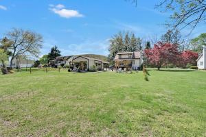 a large yard with a house in the background at Cozy Home Retreat by the River in Cressona