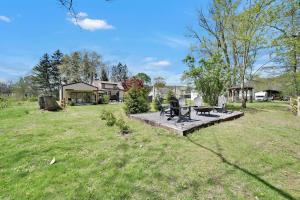 a backyard with a bench and a picnic table at Cozy Home Retreat by the River in Cressona