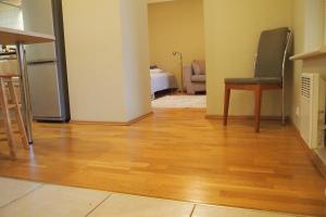 a kitchen and living room with a wooden floor at Haapsalu Old Town Apartment in Haapsalu