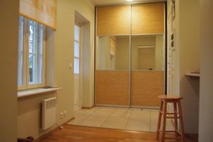 a walk in shower in a room with a stool at Haapsalu Old Town Apartment in Haapsalu +18 photos