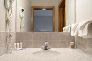 a bathroom with a sink and a mirror at Dutch Inn in Cornwall +58 photos