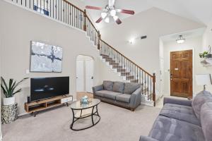 a living room with a couch and a tv at Spacious 5-BD 3-BA Forest View Getaway Sleeps 13 in Dallas