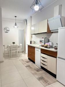 a kitchen with white appliances and a dining room at B&B Sibi in Chieti
