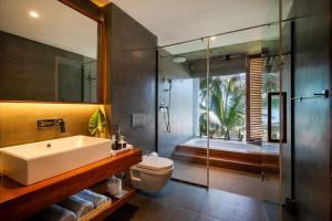a bathroom with a sink and a shower and a toilet at The Coast Sri Lanka, Bentota in Bentota +48 photos