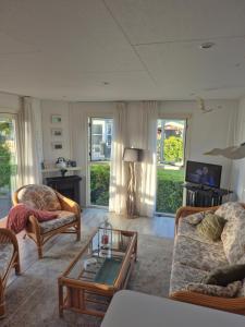 a living room with two couches and a coffee table at De vijverhut in Schagen