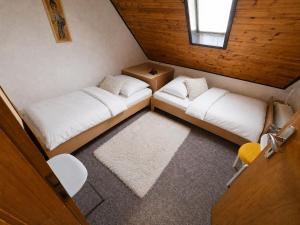a small room with two beds and a window at GreenHell Stays Monteur - Nürburg in Nürburg