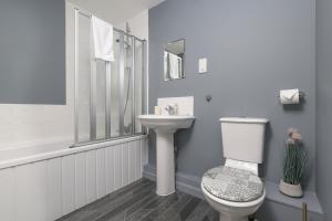 a bathroom with a toilet and a sink at Sea Point - 2 bed apartment in Saltcoats +32 photos