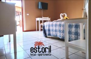 a bedroom with a bed and a table and a tiled floor at Estoril Hotel - Apartments in Sal Rei +74 photos