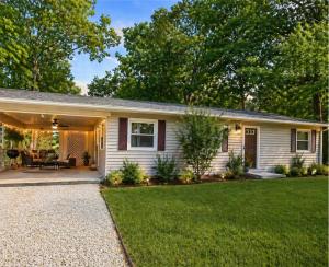 a white house with a patio and grass at Backwater Bliss 3BD, 2BA, Grill, Pet Friendly 20PP in Osage Beach