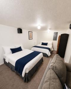 a hotel room with two beds and a couch at Backwater Bliss 3BD, 2BA, Grill, Pet Friendly 20PP in Osage Beach +20 photos