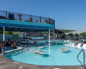 a large swimming pool with a water park at Backwater Bliss 3BD, 2BA, Grill, Pet Friendly 20PP in Osage Beach