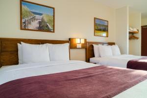 a hotel room with two beds and a beach at Dutch Inn in Cornwall