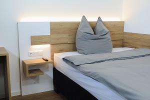 a bedroom with a bed with a pillow on it at A&E Hotel Friedrichshöhe in Braunschweig +10 photos