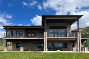 a large house with a lawn in front of it at Beach Front Haven in Laketown