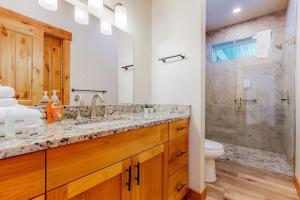 a bathroom with a shower and a sink and a toilet at Beach Front Haven in Laketown +28 photos