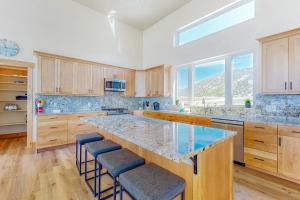 a large kitchen with a large island with stools at Beach Front Haven in Laketown