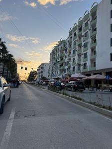 an empty city street with cars parked in front of buildings at Seaside Family Escape in Golem +7 photos