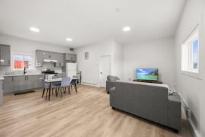 a living room with a couch and a kitchen at Private Farm Escape with Modern Comforts in Abbotsford