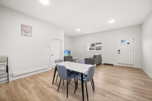 a white room with a table and chairs in it at Private Farm Escape with Modern Comforts in Abbotsford