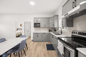 a kitchen with white cabinets and a counter top at Private Farm Escape with Modern Comforts in Abbotsford