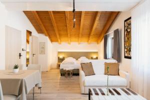 a room with four beds and a table and chairs at Residence Gold Rain in Coldrano +29 photos