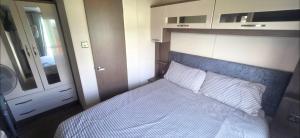a bedroom with a bed with a blue headboard at LJ Holiday Let in Middleton +37 photos