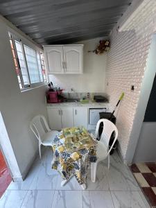 a kitchen with a table and chairs in a room at Casa Abdel in Larache