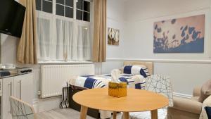 a small room with a table and a bed at Glendevon House Hotel in Bromley