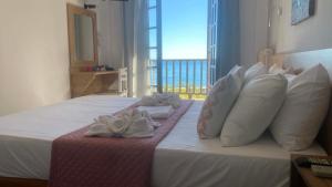 a hotel room with a bed with towels on it at Zefiros in Agios Ioannis Pelio