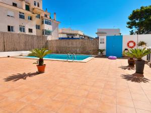 a swimming pool with potted plants next to a building at Penthouse with Sea and Mountain view by NRAS in Altea