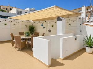 a patio with a table and a roof at Penthouse with Sea and Mountain view by NRAS in Altea