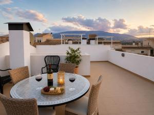 a table with wine glasses on a balcony with a view at Penthouse with Sea and Mountain view by NRAS in Altea