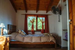 a bed in a room with a window at Altos del Pucara Piscina Climatizada vista a las sierras juegos Huerta Orgánica in Huerta Grande +87 photos