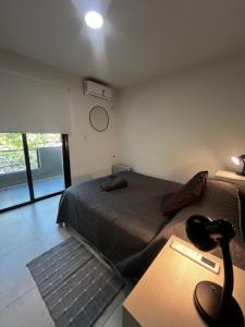 a bedroom with two beds and a table with a lamp at Andes Nomad Mendoza in Godoy Cruz