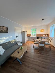 a living room with a couch and a table at Haus Wally - Ferienwohnungen in Klitten