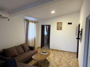 a living room with a couch and a table at Apartments Sole1 in Sutomore