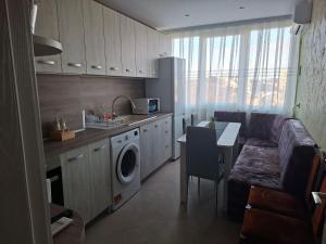 a kitchen with a couch and a table in a room at Harmonia in Ruse