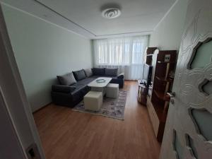 a living room with a couch and a table at Harmonia in Ruse
