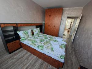 a bedroom with a large bed with a wooden headboard at Harmonia in Ruse